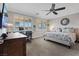 Main bedroom with king-size bed, built-in desk, and large windows with plantation shutters at 1221 Olivia Pkwy, Henderson, NV 89011