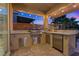 Outdoor kitchen with grill and refrigerator at 1221 Olivia Pkwy, Henderson, NV 89011