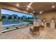 Relaxing outdoor kitchen and seating area overlooking the pool and backyard at 12456 Edinburgh Cask Ave, Las Vegas, NV 89138