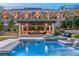 Covered patio with seating area adjacent to the pool and spa at 12456 Edinburgh Cask Ave, Las Vegas, NV 89138