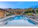 Relaxing pool and spa with waterfall features and a covered patio area at 12456 Edinburgh Cask Ave, Las Vegas, NV 89138