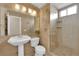 Bathroom boasts a large shower, tile flooring, and a pedestal sink at 1326 Summer Dawn Ave, Henderson, NV 89014