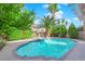 Inviting kidney-shaped pool surrounded by lush landscaping at 1326 Summer Dawn Ave, Henderson, NV 89014