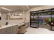 Bathroom with double vanity and sliding glass doors opening to a private patio at 1485 Placid Coast Ct, Henderson, NV 89011