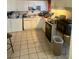 Kitchen with white cabinets, appliances, and tiled floor at 1924 Hart Ave, North Las Vegas, NV 89032