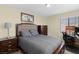 Cozy bedroom with a queen-size bed, dresser, and home office space at 1932 Barrow Glen Ct, North Las Vegas, NV 89084