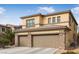 Two-story house with a three-car garage and stone accents at 1932 Barrow Glen Ct, North Las Vegas, NV 89084