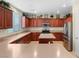 Kitchen with wood cabinets, an island, and stainless steel appliances at 1932 Barrow Glen Ct, North Las Vegas, NV 89084