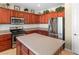 Kitchen with wood cabinets and stainless steel appliances at 1932 Barrow Glen Ct, North Las Vegas, NV 89084