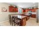 Spacious kitchen with wood cabinets, an island, and stainless steel appliances at 1932 Barrow Glen Ct, North Las Vegas, NV 89084