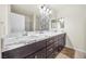 Double vanity bathroom with marble countertop and modern dark brown cabinets at 2005 Ona Marie Ave, North Las Vegas, NV 89032