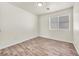 Well-lit bedroom with wood-look flooring and a window with blinds at 2005 Ona Marie Ave, North Las Vegas, NV 89032