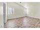 Bright and airy bedroom with wood-look flooring and two windows at 2005 Ona Marie Ave, North Las Vegas, NV 89032