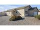 Single-story house with a white garage door and rock landscaping at 2005 Ona Marie Ave, North Las Vegas, NV 89032