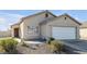 Single-story house with a white garage door and desert landscaping at 2005 Ona Marie Ave, North Las Vegas, NV 89032