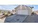 Single-story house with a white garage door and desert landscaping at 2005 Ona Marie Ave, North Las Vegas, NV 89032