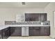 Kitchen with dark brown cabinets, white countertops, and mosaic backsplash at 2005 Ona Marie Ave, North Las Vegas, NV 89032