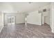 Open living room with grey vinyl plank flooring and access to backyard at 2005 Ona Marie Ave, North Las Vegas, NV 89032