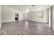 Spacious living room with grey vinyl plank flooring and access to the kitchen at 2005 Ona Marie Ave, North Las Vegas, NV 89032