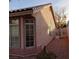 View of the home's side, featuring a gated access and large windows at 2108 Buckeye Reef St, Henderson, NV 89002