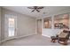 Comfortable bedroom with french doors leading to the backyard and a ceiling fan at 3267 Royal Fortune Dr, Las Vegas, NV 89141