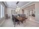 Bright dining room featuring a large wooden table and modern light fixture at 3267 Royal Fortune Dr, Las Vegas, NV 89141