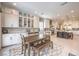 Eat-in kitchen with white cabinetry, breakfast nook, and views of the backyard at 3267 Royal Fortune Dr, Las Vegas, NV 89141