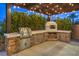 Outdoor kitchen with grill and pizza oven at 3267 Royal Fortune Dr, Las Vegas, NV 89141