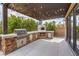 Outdoor kitchen with pizza oven and built-in grill at 3267 Royal Fortune Dr, Las Vegas, NV 89141