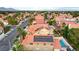 Aerial view of a house with solar panels, a pool, and a red tile roof at 3320 Haven Beach Way, Las Vegas, NV 89117