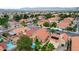 Aerial view of homes with pools, complemented by palm trees and lush greenery, set against a mountain backdrop at 3320 Haven Beach Way, Las Vegas, NV 89117