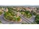 Aerial view of a residential neighborhood with lush landscaping and a community pond at 3320 Haven Beach Way, Las Vegas, NV 89117