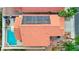 Aerial of a house with solar panels, a pool, an outdoor dining set and tropical palm trees at 3320 Haven Beach Way, Las Vegas, NV 89117