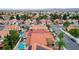 Aerial view of house, pool, and neighborhood with mountain views at 3320 Haven Beach Way, Las Vegas, NV 89117