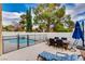 Relaxing backyard with pool, patio furniture, and lush landscaping at 3320 Haven Beach Way, Las Vegas, NV 89117