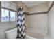 Bathroom with tub, shower, and chevron-patterned curtain at 3320 Haven Beach Way, Las Vegas, NV 89117