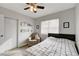 Bedroom with reading chair, floating shelves, and ceiling fan at 3320 Haven Beach Way, Las Vegas, NV 89117