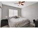 Cozy bedroom featuring a ceiling fan, large window, and comfortable bedding at 3320 Haven Beach Way, Las Vegas, NV 89117