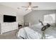 Bright bedroom featuring a ceiling fan, crib, flatscreen tv, and white dresser at 3320 Haven Beach Way, Las Vegas, NV 89117