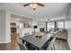 Open concept living and dining room area with hardwood floors, fireplace and kitchen view at 3320 Haven Beach Way, Las Vegas, NV 89117