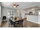 Bright dining room with dark wood table and six gray chairs at 3320 Haven Beach Way, Las Vegas, NV 89117