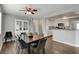 Bright dining area with modern table set adjacent to a kitchen bar and a hutch at 3320 Haven Beach Way, Las Vegas, NV 89117