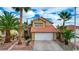Inviting home exterior showcases a tiled roof, a two-car garage, and drought resistant landscaping at 3320 Haven Beach Way, Las Vegas, NV 89117