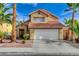 Two-story house with a terracotta roof, two-car garage, and desert landscaping at 3320 Haven Beach Way, Las Vegas, NV 89117