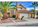 Charming two-story home featuring a well-manicured front yard with mature palm trees and a red tile roof at 3320 Haven Beach Way, Las Vegas, NV 89117