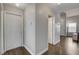 Hallway with neutral walls and hardwood flooring leading to other rooms in the home at 3320 Haven Beach Way, Las Vegas, NV 89117