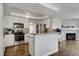 Modern kitchen featuring stainless steel appliances, granite countertops, and stylish white cabinetry at 3320 Haven Beach Way, Las Vegas, NV 89117