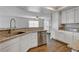 Kitchen with stainless steel appliances and granite countertops overlooking an open floorplan at 3320 Haven Beach Way, Las Vegas, NV 89117