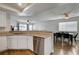 Kitchen with stainless steel dishwasher and granite countertops overlooking an open floorplan at 3320 Haven Beach Way, Las Vegas, NV 89117