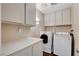 Bright laundry room with washer, dryer, and ample cabinetry at 3320 Haven Beach Way, Las Vegas, NV 89117